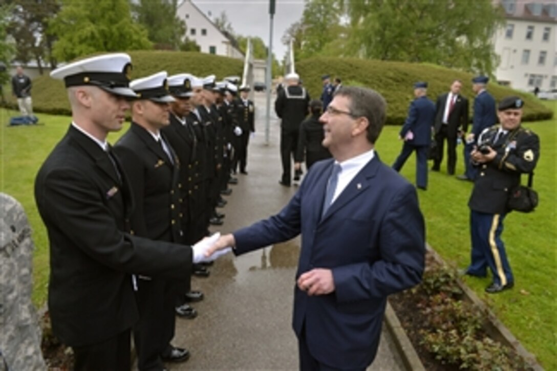 Deputy Secretary of Defense Ashton B. Carter congratulates the service members who fired the ceremonial cannons during the European Command change of command ceremony at Patch Barracks in Stuttgart, Germany, on May 10, 2013.  Carter addressed the audience during the ceremony where U.S. Navy Adm. James G. Stavridis was relieved by Air Force Gen. Phillip M. Breedlove as commander, European Command.