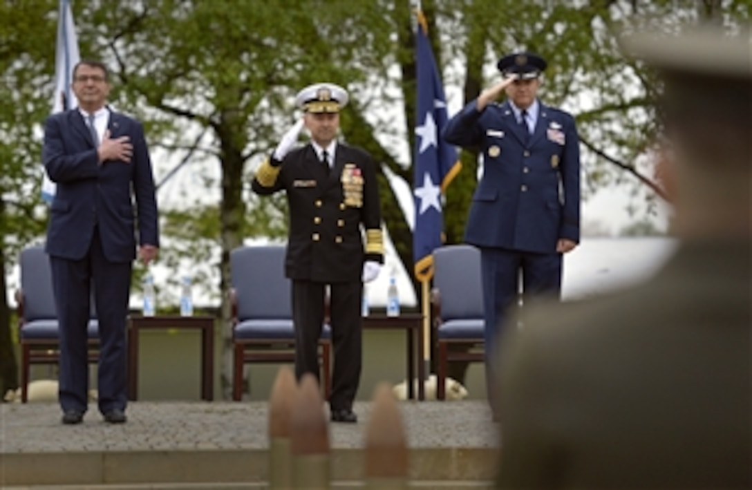 Deputy Secretary of Defense Ashton B. Carter, left, places his hand over his heart as Navy Adm. James G. Stavridis and Air Force Gen. Phillip M. Breedlove salute the colors at the start of the European Command change of command ceremony at Patch Barracks in Stuttgart, Germany, on May 10, 2013.  Stavridis will be relieved by Breedlove as commander, European Command.  