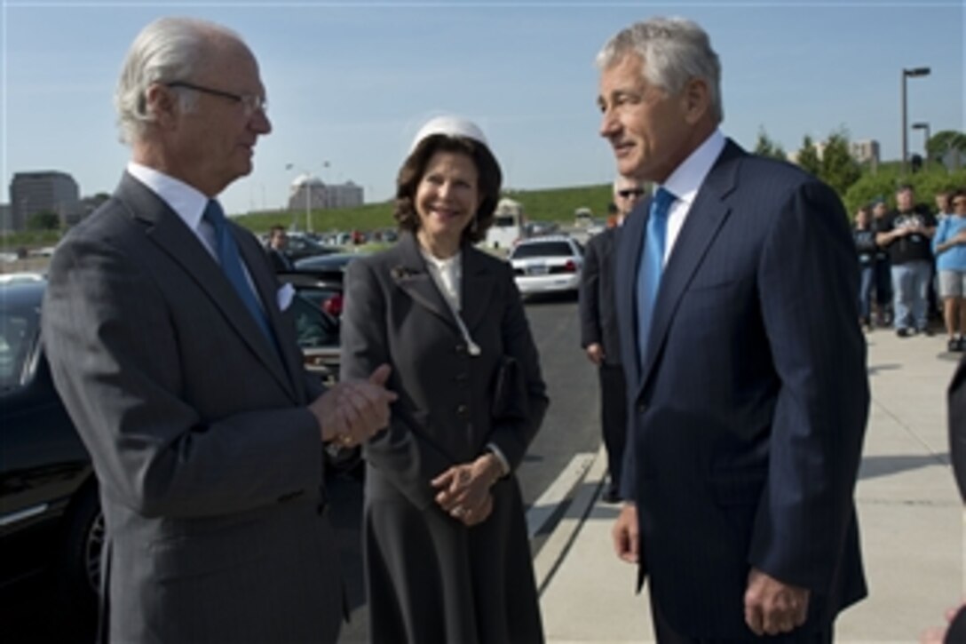 Secretary of Defense Chuck Hagel, right, welcomes Carl XVI Gustaf, King of Sweden and his wife Queen Silvia prior to a tour of the Pentagon Memorial on May 10, 2013.  The king and queen will receive a guided tour of the memorial by the President of the Pentagon Memorial Fund Jim Laychak.  