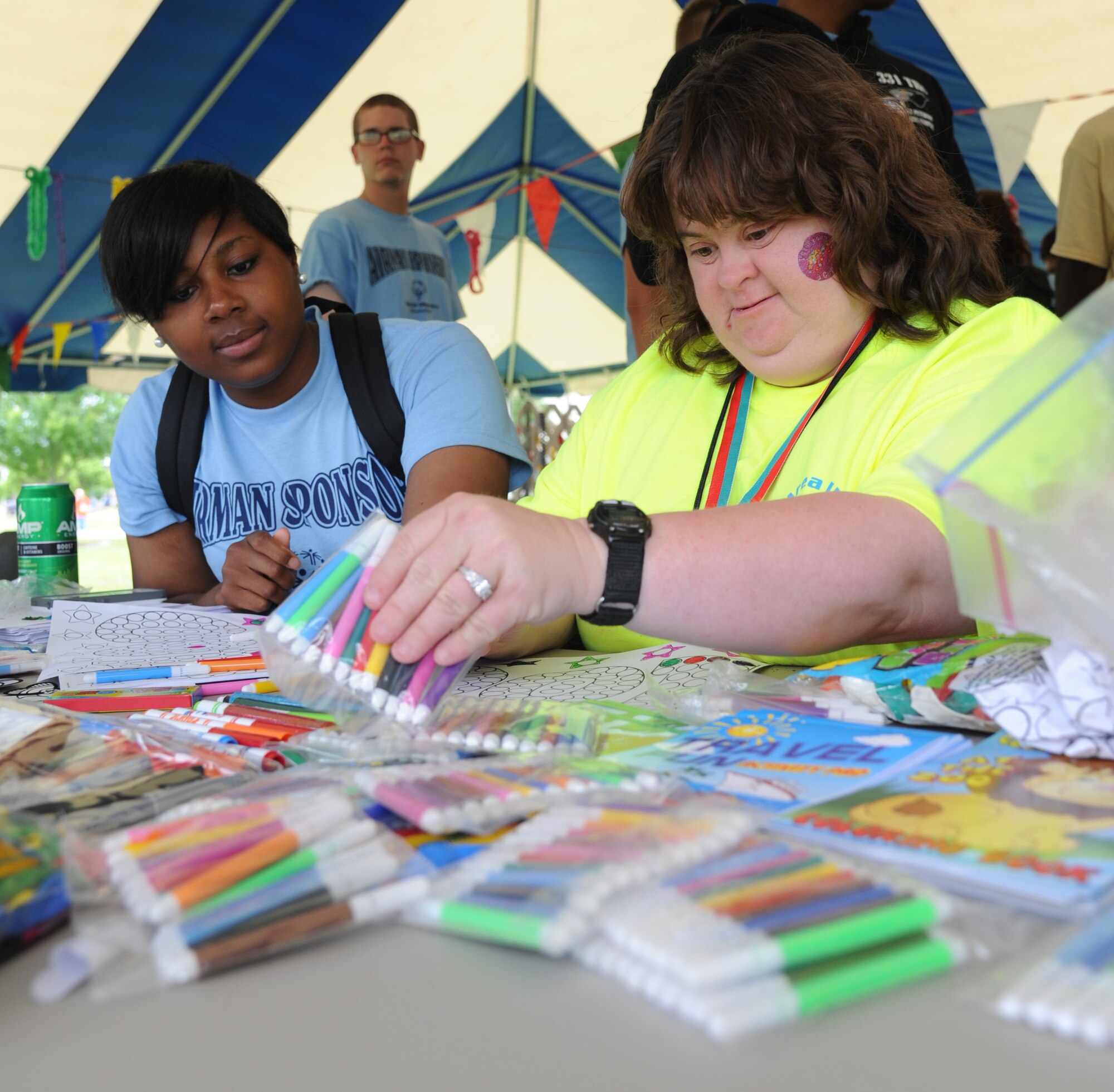 Airman 1st Class Brittney Ross, 335th Training Squadron, does arts and crafts with Dana Brannon, athlete, during the Special Olympics Mississippi Summer Games on May 11, 2013, at Keesler Air Force Base, Miss.  More than 900 athletes and 3,000 volunteers worked together to hold competitions throughout the day.  This is the 27th year Keesler has hosted the state Special Olympics.   (U.S. Air Force photo by Kemberly Groue)