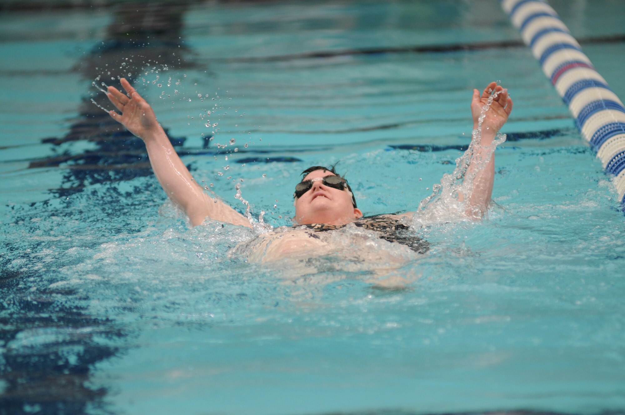Michelle Bonner, athlete, swims in the 25 meter back stroke during the Special Olympics Mississippi Summer Games on May 11, 2013, at the Biloxi natatorium.  More than 900 athletes and 3,000 volunteers worked together to hold competitions throughout the day.  This is the 27th year Keesler Air Force Base has hosted the state Special Olympics.   (U.S. Air Force photo by Kemberly Groue)  