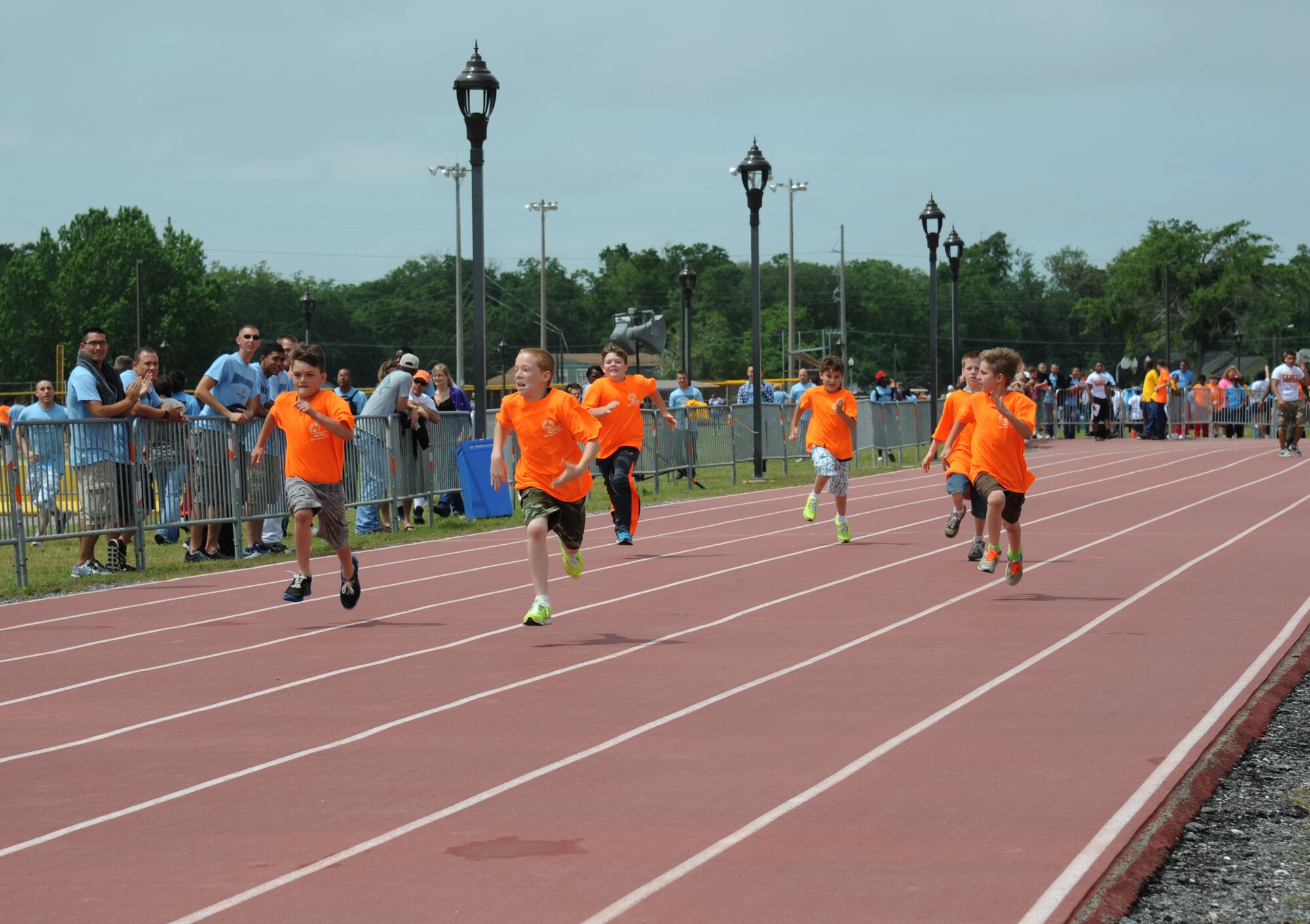 Athletes compete in the 100-meter dash event during the Special Olympics Mississippi Summer Games on May 11, 2013, at Keesler Air Force Base, Miss.  More than 900 athletes and 3,000 volunteers worked together to hold competitions throughout the day.  This is the 27th year Keesler has hosted the state Special Olympics.   (U.S. Air Force photo by Kemberly Groue)