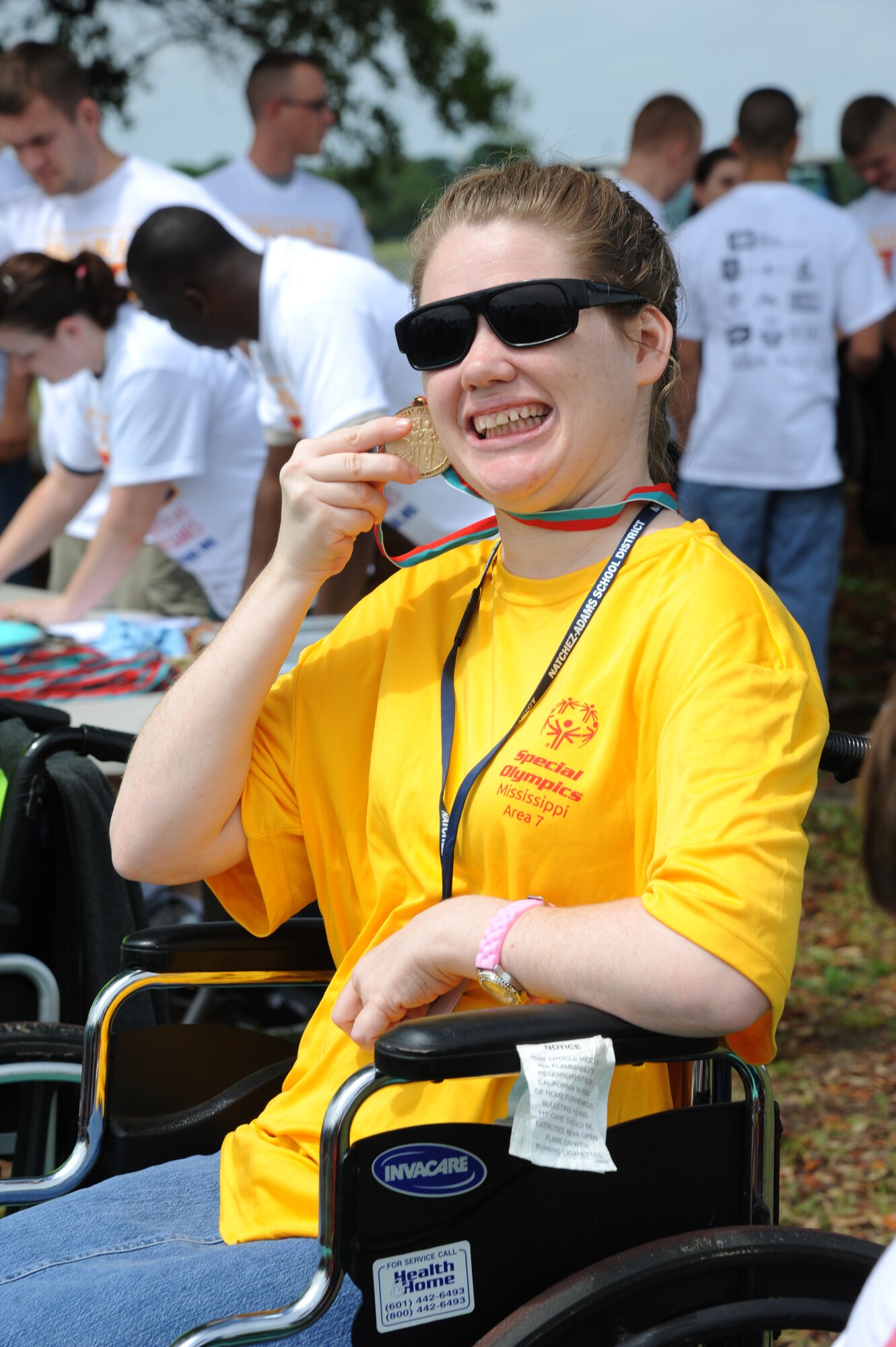 Britni Welch, athlete, displays the gold medal she won in the 25-meter wheel chair event  during the Special Olympics Mississippi Summer Games on May 11, 2013, at Keesler Air Force Base, Miss.  More than 900 athletes and 3,000 volunteers worked together to hold competitions throughout the day.  This is the 27th year Keesler has hosted the state Special Olympics.   (U.S. Air Force photo by Kemberly Groue)
