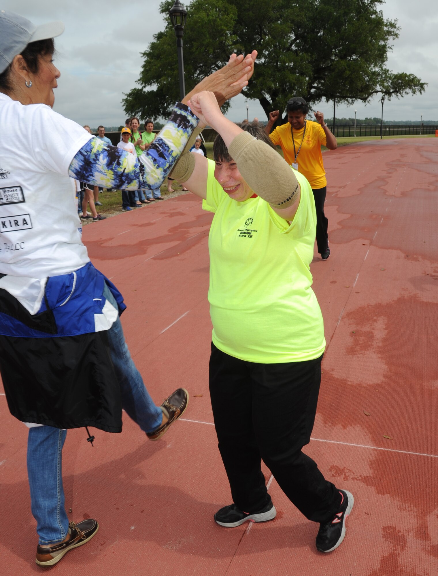 May Lynn Lowery, volunteer, congratulates Vicky Randolph, athlete, following the 25-meter assisted walk during the Special Olympics Mississippi Summer Games on May 11, 2013, at Keesler Air Force Base, Miss.  More than 900 athletes and 3,000 volunteers worked together to hold competitions throughout the day.  This is the 27th year Keesler has hosted the state Special Olympics.   (U.S. Air Force photo by Kemberly Groue)