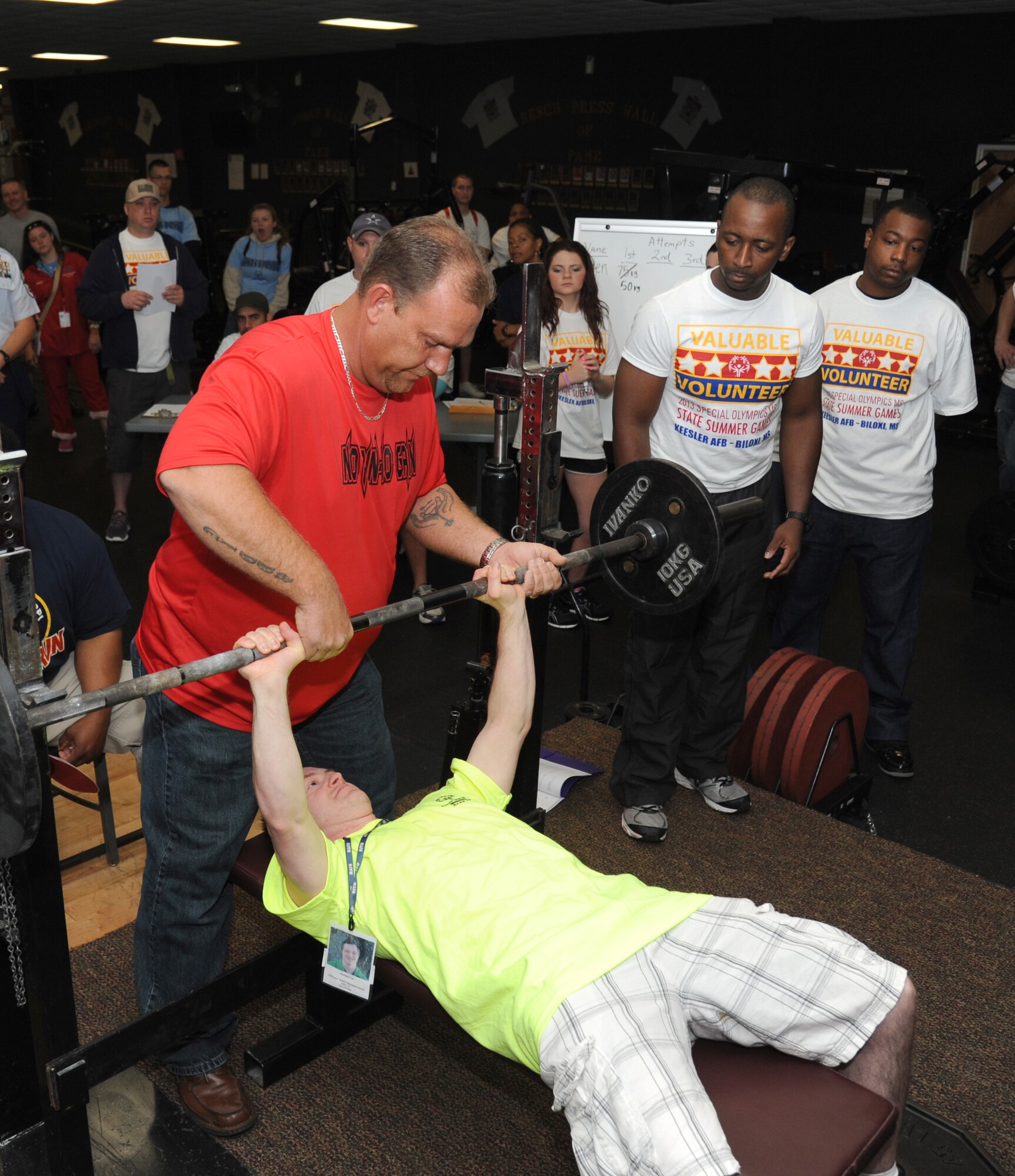 Jimmie Dunlap, coach, assists Kenneth Frye, athlete, as Tech. Sgt. Travis Spencer, Keesler NCO Academy, and Staff Sgt. Jeremy Blakey, 81st Medical Support Squadron, stands by to help during the powerlifting competition at the Special Olympics Mississippi Summer Games on May 11, 2013, at the Triangle Fitness Center, Keesler Air Force Base, Miss.  More than 900 athletes and 3,000 volunteers worked together to hold competitions throughout the day.  This is the 27th year Keesler has hosted the state Special Olympics.   (U.S. Air Force photo by Kemberly Groue)