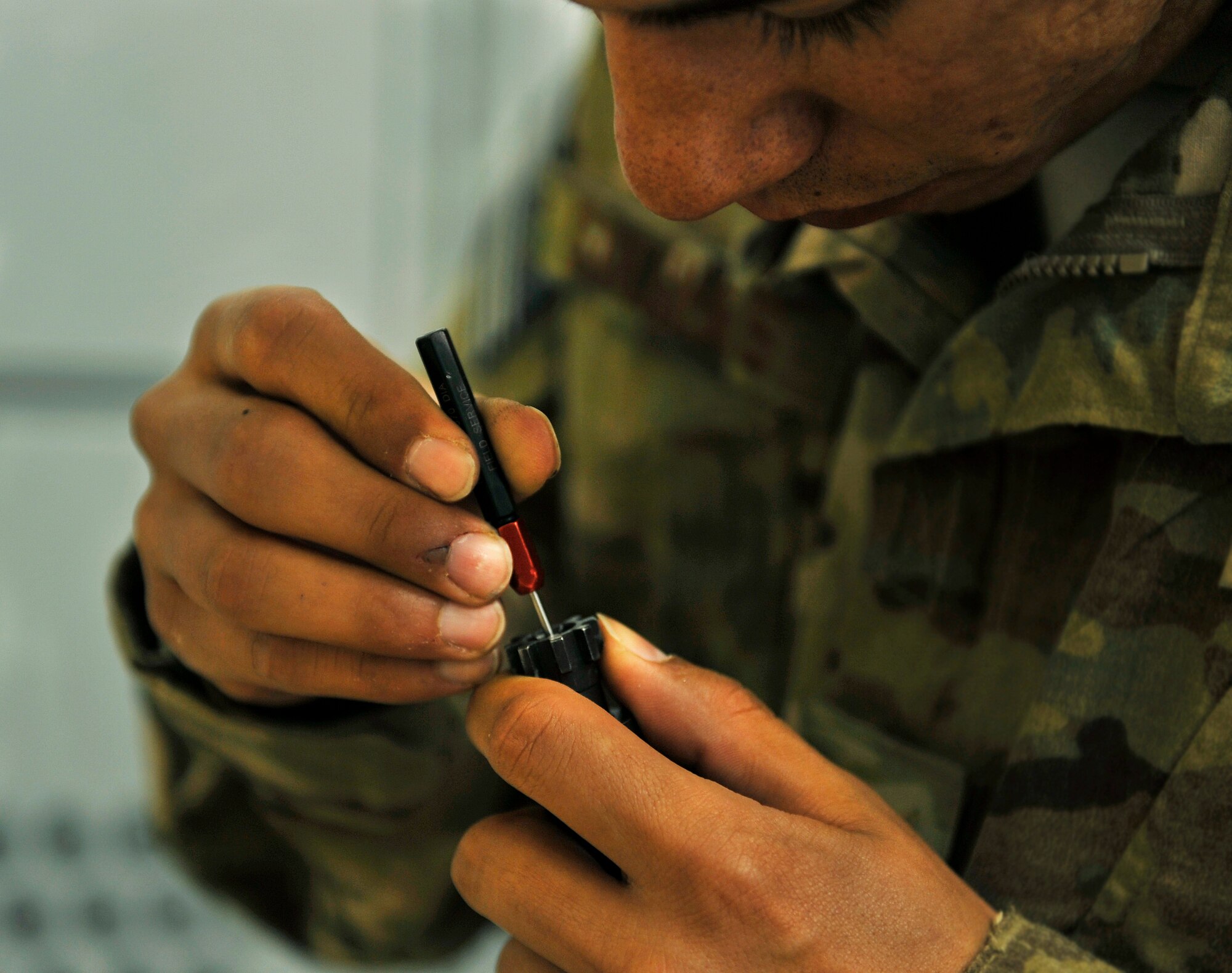 Staff Sgt. Ryan Salinas, 455th Expeditionary Security Forces Group Combat Arms Training and Maintenance technician, works on the bolt of an M4 rifle to return the weapon to serviceable condition in the armory on Bagram Airfield, Afghanistan, May 11, 2013. Once a week a member from CATM comes to inspect and repair weapons. (U.S. Air Force photo/ Staff Sgt. Stephenie Wade)