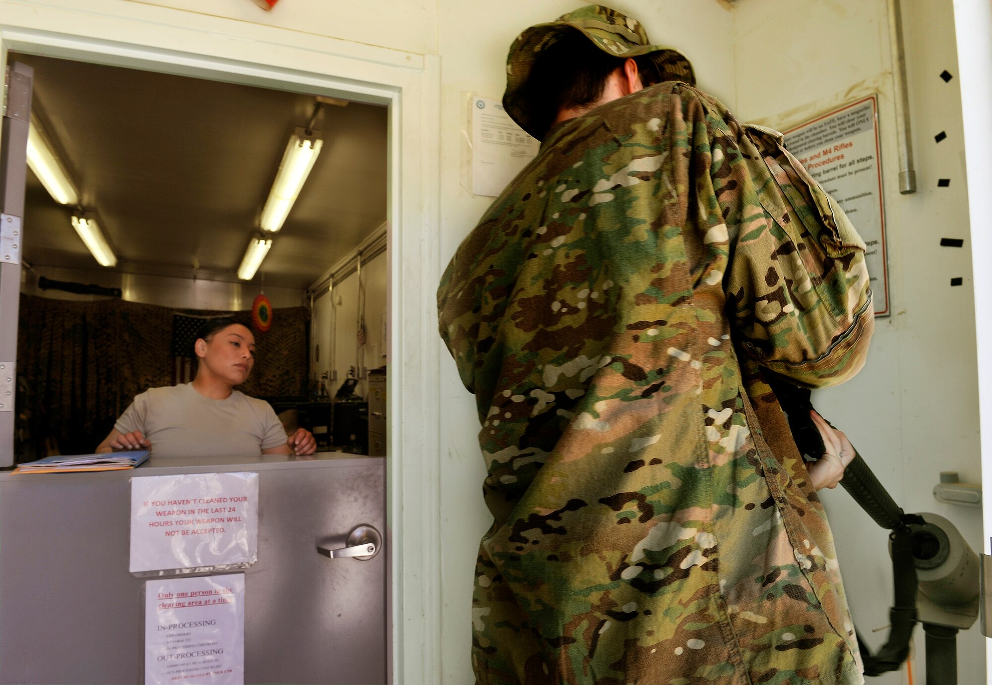 Staff Sgt. Cynthia Lopez, 455th Expeditionary Logistics Readiness Squadron Armory NCO in charge, supervises as an Airman clears his M4 pistol prior to returning it to the armory on Bagram Airfield, Afghanistan, May 11, 2013. The armory provides a one-stop centralized and secure location for weapons distribution to all 455th Air Expeditionary Wing Airmen. (U.S. Air Force photo/ Staff Sgt. Stephenie Wade)