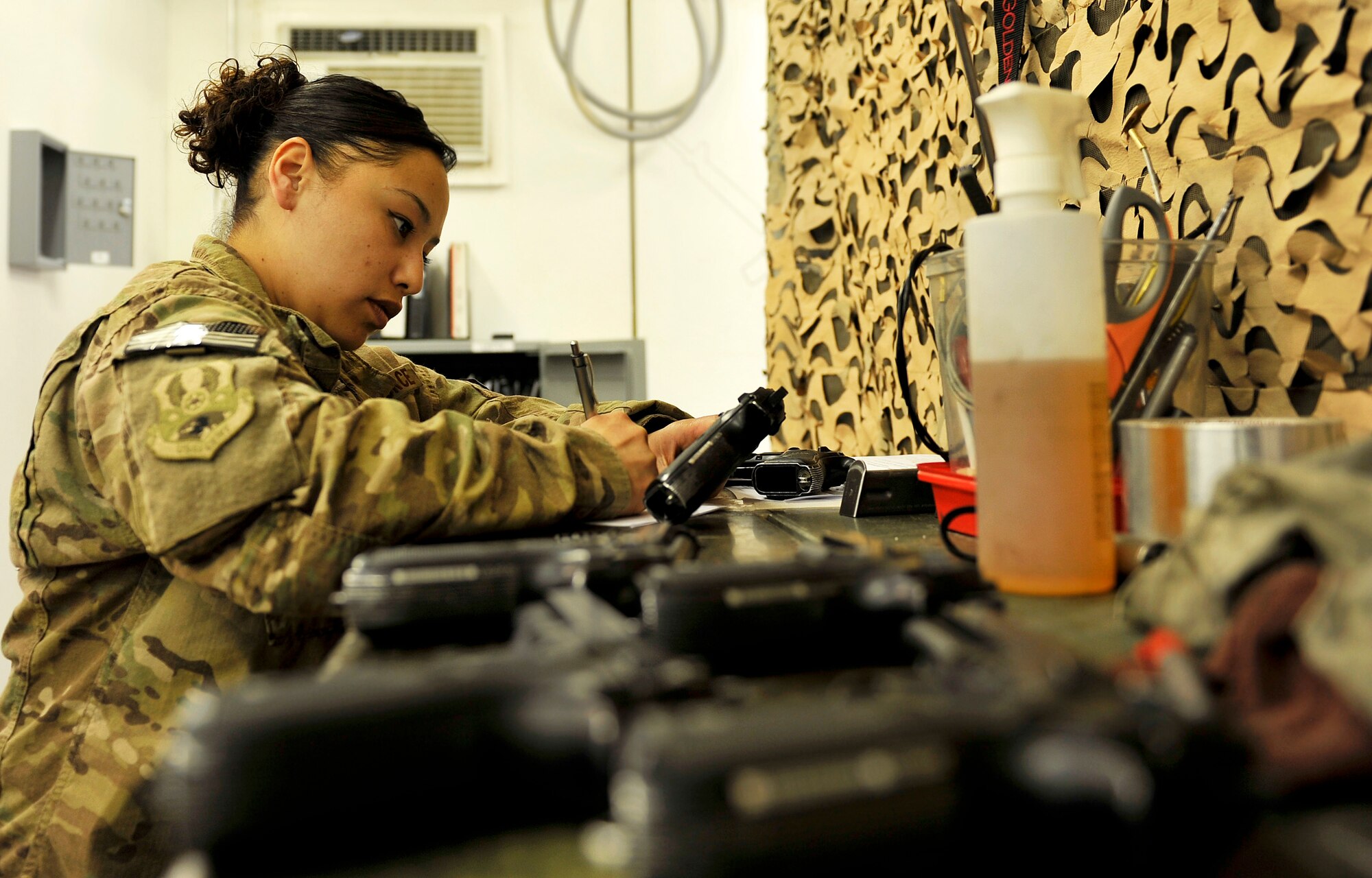 Staff Sgt. Cynthia Lopez, 455th Expeditionary Logistics Readiness Squadron Armory NCO in charge, inventories damaged M9 pistols in the armory on Bagram Airfield, Afghanistan, May 10, 2013. The armory opened in August 2012 and is responsible for more than 3,000 weapons on base. (U.S. Air Force photo/ Staff Sgt. Stephenie Wade)