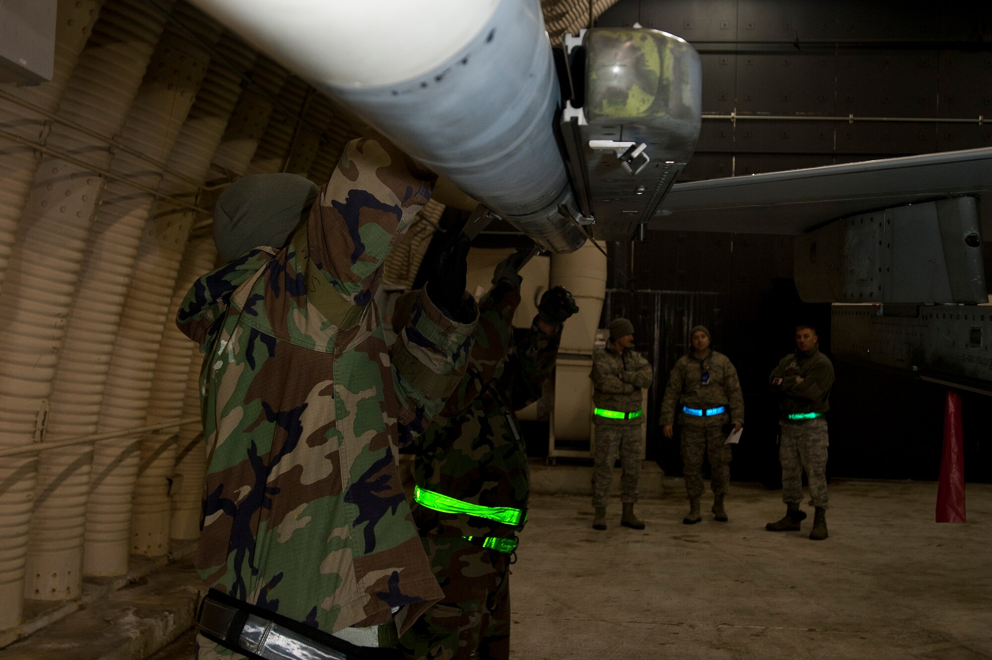 KUNSAN AIR BASE, Republic of Korea – Staff Sgt. Terrelle Sayles, front, 8th Maintenance Operations Squadron, load standardization team chief installs a wing fin, while Senior Airman Kevin Johnson, 8th MOS load standardization 2-man, installs a tail fin on a AIM-9X Sidewinder missile during exercise Beverly Bearcat 13-1, at Kunsan Air Base, Republic of Korea, April 10, 2013. 7th Air Force Inspector Generals, foreground, evaluated the weapons loaders on their duties during the 2013 Pacific Air Force Readiness Inspection.  (U.S. Air Force photo by Staff Sgt. Tong Duong/ Released)