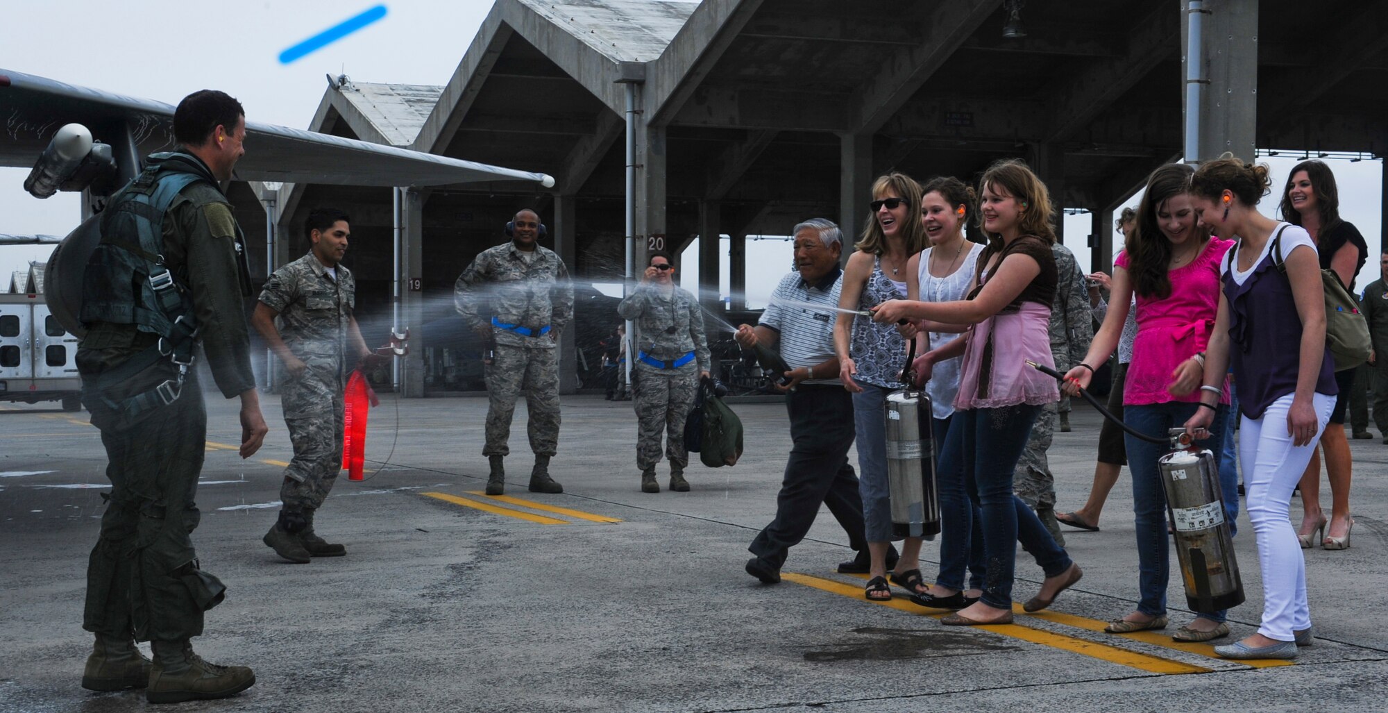 Kati Molloy and her daughters hose down U.S. Air Force Brig. Gen. Matt Molloy, former 18th Wing commander, after he landed from his "fini-flight" in an F-15 Eagle on Kadena Air Base, Japan, May 9, 2013. Molloy is preparing to leave Kadena and assume the position of deputy director of operations, Headquarters U.S. Northern Command, Peterson Air Force Base, Colo. (U.S. Air Force photo by Airman 1st Class Justin Veazie/Released)