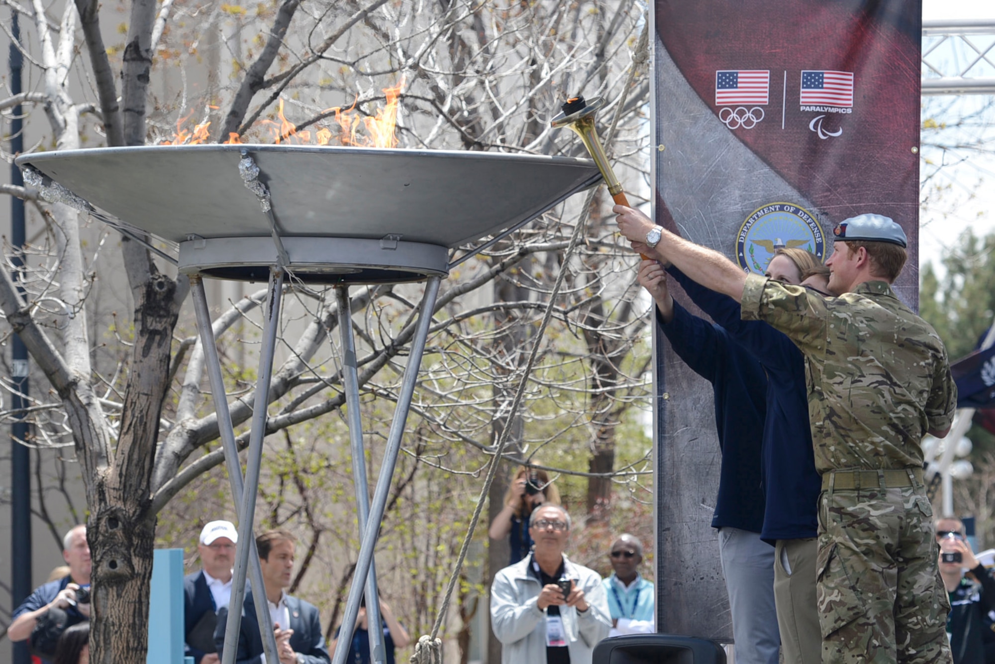 Paralympian gold medal winner Navy Lt. Bradley Snyder, with the help of Prince Harry and olympian Missy Franklin, light the official torch to begin the 2013 Warrior Games at the U.S. Olympic Training Center in Colorado Springs, Colo., May 11, 2013. From May 11-16, more than 200 wounded, ill and injured servicemembers and veterans from the U.S. Marines, Army, Air Force and Navy, as well as a team representing U.S. Special Operations Command and an international team representing the United Kingdom, will compete for the gold in track and field, shooting, swimming, cycling, archery, wheelchair basketball and sitting volleyball at the U.S. Olympic Training Center and U.S. Air Force Academy. The military service with the most medals will win the Chairman's Cup. (DoD photo/EJ Hersom)