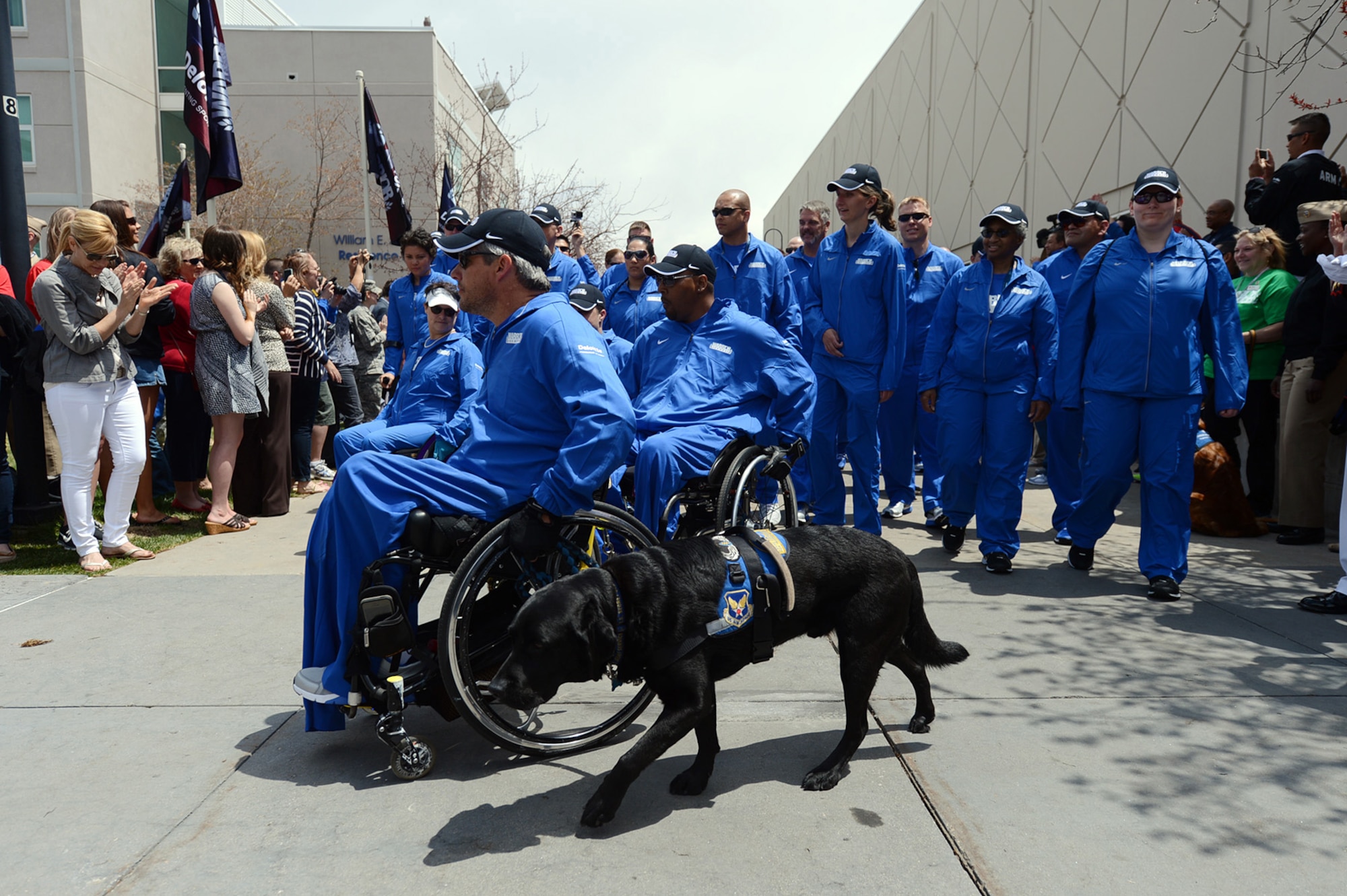 Team Air Force athletes enter the U.S. Olympic Training Center during the opening ceremony for the 2013 Warrior Games in Colorado Springs, Colo., May 11. 2013. From May 11-16, more than 200 wounded, ill and injured servicemembers and veterans from the U.S. Marines, Army, Air Force and Navy, as well as a team representing U.S. Special Operations Command and an international team representing the United Kingdom, will compete for the gold in track and field, shooting, swimming, cycling, archery, wheelchair basketball and sitting volleyball at the U.S. Olympic Training Center and U.S. Air Force Academy. The military service with the most medals will win the Chairman's Cup. (DoD photo/EJ Hersom)