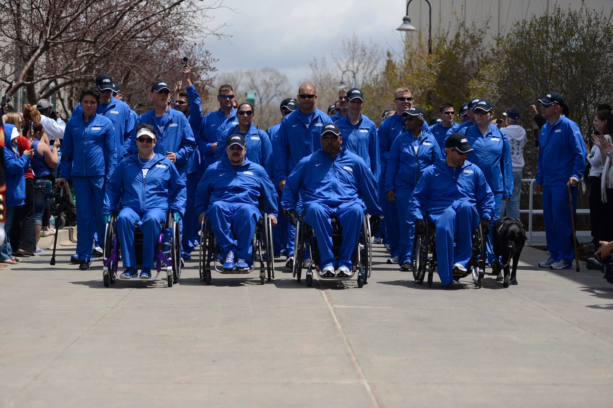 Team Air Force enters the U.S. Olympic Training Center for the opening ceremony of the 2013 Warrior Games in Colorado Springs, Colo., May 11, 2013. From May 11-16,more than 200 wounded, ill and injured servicemembers and veterans from the U.S. Marines, Army, Air Force and Navy, as well as a team representing U.S. Special Operations Command and an international team representing the United Kingdom, will compete for the gold in track and field, shooting, swimming, cycling, archery, wheelchair basketball and sitting volleyball at the U.S. Olympic Training Center and U.S. Air Force Academy. The military service with the most medals will win the Chairman's Cup. (DoD photo/EJ Hersom)