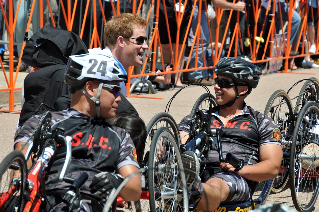 Prince Harry offers words of encouragement and jokes around with Marine Sgt. Eric Rodriguez and Marine Ronnie Jimenez, number 24, before the start of the 2013 Warrior Games recumbent bike cycling competition near the U.S. Air Force Academy in Colorado Springs, Colo., May 11. Jimenez went on to earn the gold medal for the event. From May 11-16, more than 200 wounded, ill and injured servicemembers and veterans from the U.S. Marines, Army, Air Force and Navy, as well as a team representing U.S. Special Operations Command and an international team representing the United Kingdom, will compete for the gold in track and field, shooting, swimming, cycling, archery, wheelchair basketball and sitting volleyball at the U.S. Olympic Training Center and U.S. Air Force Academy. The military service with the most medals will win the Chairman's Cup.