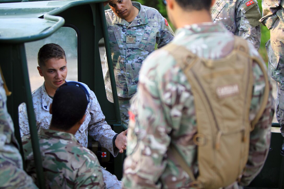 Cpl. Erikon C. Rosamond (left), a Kosciusko. Miss., native and combat engineer with Bridge Company, 8th Engineer Support Battalion, 2nd Marine Logistics Group, teaches soldiers with the Bermuda Regiment the nomenclature and characteristics of the MK III Bridge Erection Boat during Exercise Island Warrior at Engineer Point aboard Camp Lejeune, N.C., May 7, 2013. Approximately 15 soldiers with the Bermuda Regiment came to enhance their engineer skills with the 8th ESB Marines.