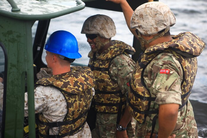 Soldiers with the Bermuda Regiment ask a Marine with 8th Engineer Support Battalion, 2nd Marine Logistics Group questions about the MK III Bridge Erection Boats during Exercise Island Warrior aboard Camp Lejeune, N.C., May 7, 2013. The Bermuda Regiment soldiers come from the Islands of Bermuda. The main island is a 20.6 square-mile island where they have limited space to train. 