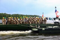 The Hon. George D. R. Fergusson (center), Governor of Bermuda, poses with soldiers with the Bermuda Regiment and Marines with 8th Engineer Support Battalion, 2nd Marine Logistics Group during Exercise Island Warrior aboard Camp Lejeune, N.C., May 7, 2013. Soldiers with the Bermuda Regiment received hands-on training from the Marines with 8th ESB on how to operate the MK III Bridge Erection Boats and to use them to construct and maneuver Improved Ribbon Bridges. 