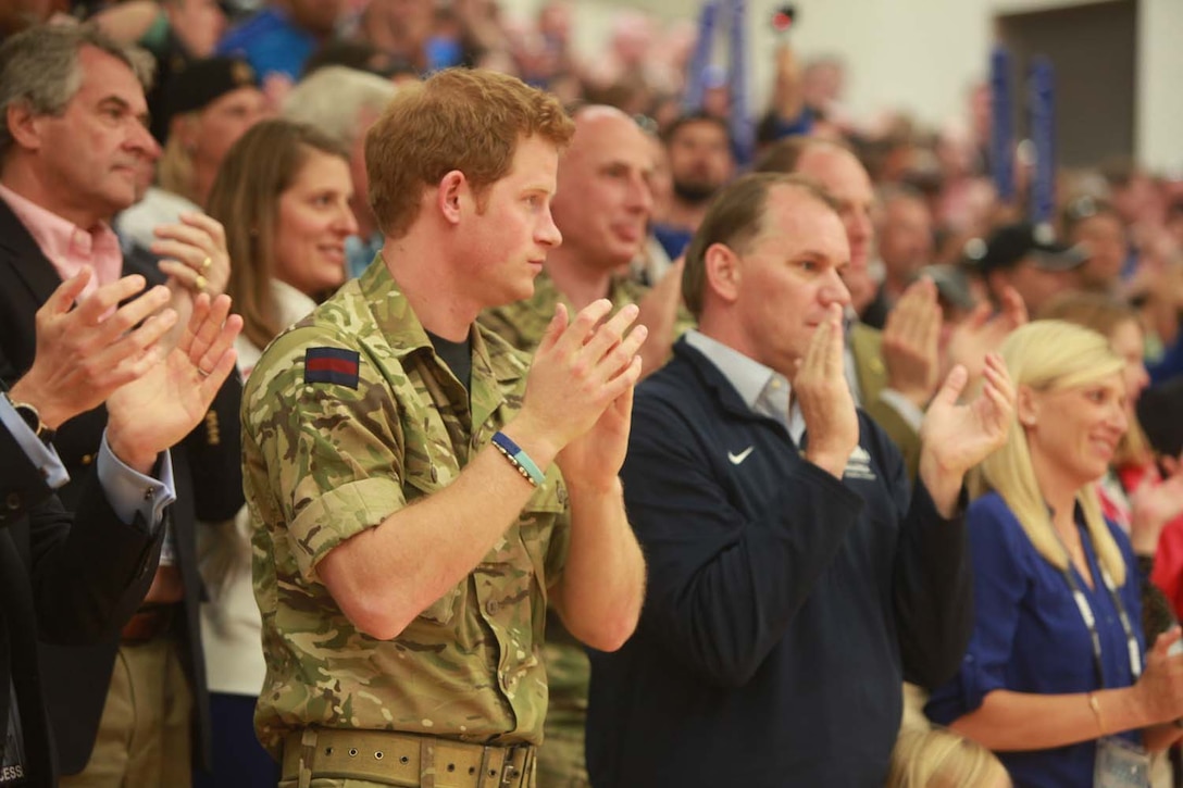 Prince Harry applauds the Silent Drill Platoon from Marine Barracks Washington, while they perform aboard the U.S. Olympic Training Center in Colorado Springs, Colo., May 11. The platoon performed following the opening ceremony of the 2013 Warrior Games, a Paralympic-style competition where more than 260 wounded, ill or injured service members and veterans will compete for gold in archery, swimming, wheelchair basketball, sitting volleyball, track and field and cycling. The Warrior Games provides athletes an opportunity to fine tune their athletic skills, strengthen their bodies and support each other through their recovery process.