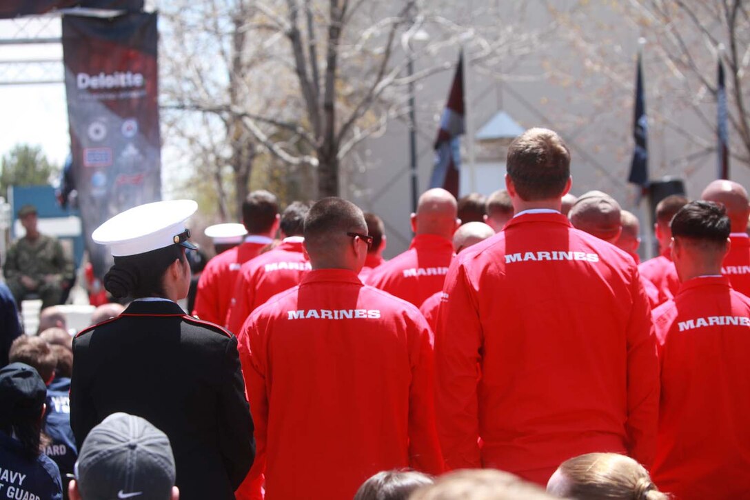 Marines stand for the Marines Hymn at the opening ceremony of the 2013 Warrior Games. Athletes will compete in swimming, track and field, volleyball, wheelchair basketball, cycling, shooting and archery.  The Marine Warrior Games team will defend their championship title against the Army, Navy /Coast Guard, Air Force and SOCOM. Photo by Lance Cpl. Scott Reel