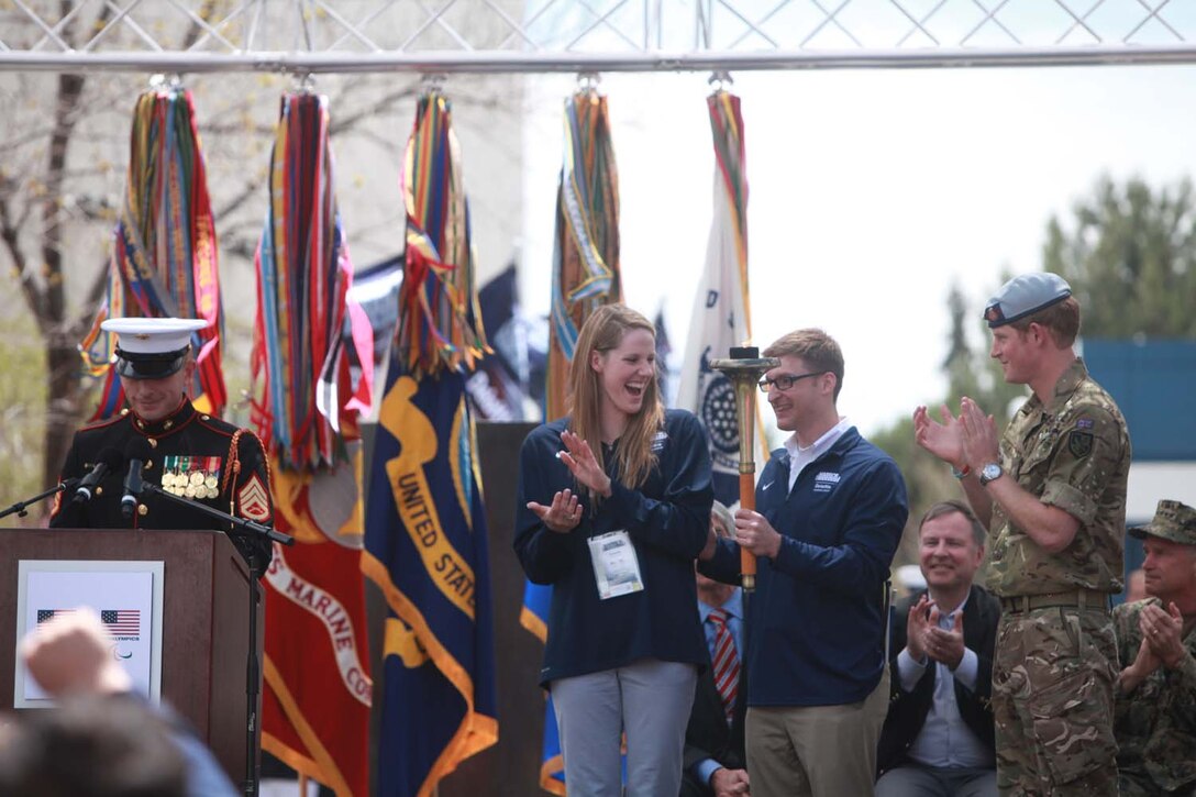 Navy Lt. Bradley Snyder, a gold medalist Paralympic swimmer was the honorary torchbearer at the opening ceremony of the 2013 Warrior Games. Snyder competed in the Warrior Games before qualifying for the Paralympics. The fourth annual Warrior Games will be held at the Olympic Training Center and Air Force Academy in Colorado Springs, Colo., May 10-16.  Athletes will compete in swimming, track and field, volleyball, wheelchair basketball, cycling, shooting and archery.  The Marine Warrior Games team will defend their championship title against the Army, Navy /Coast Guard, Air Force and SOCOM. Photo by Lance Cpl. Scott Reel