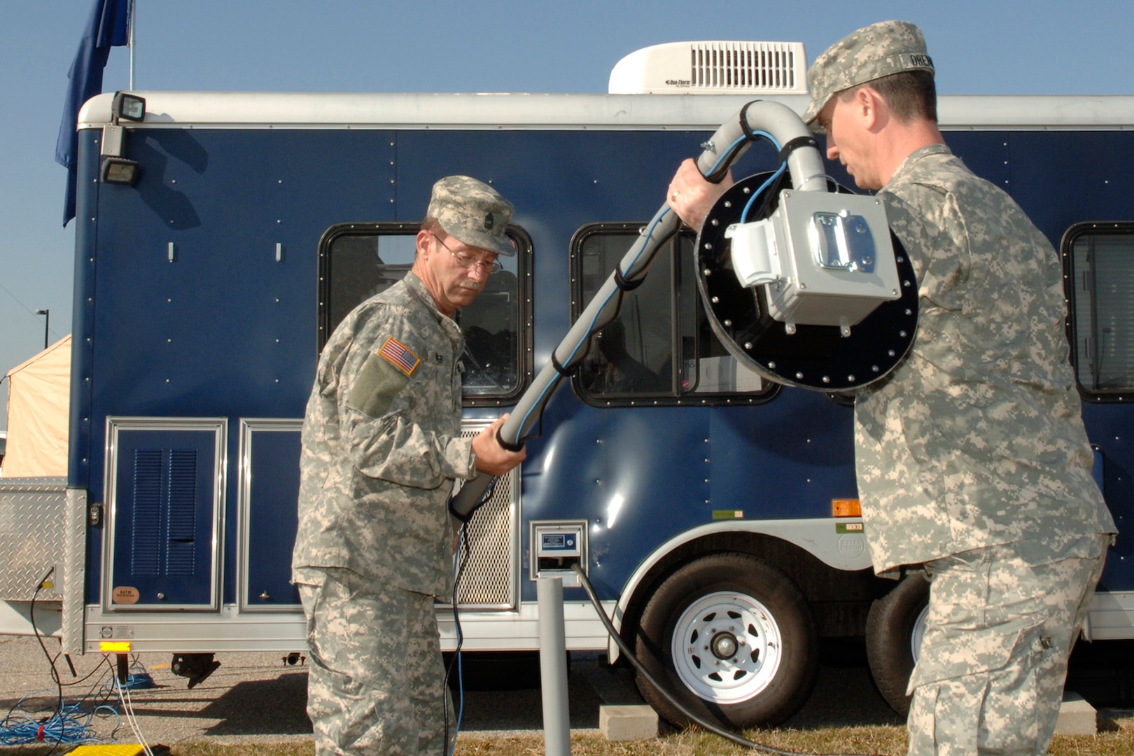 Chief Warrant Officer Ken Drennon and Master Sergeant Michael Winkler, of the South Carolina National Guard, Set up a Web Cam as part of Defense Interoperability Communication Exercise 2007 (DICE07).  DICE07 is a joint exercise, incorporating both DoD and non-DoD agency communications systems, with a goal of creating interoperability procedures that ensure robust support for global war on terror efforts and responses to natural disasters such as Hurricane Katrina. Photo by Mass Communication Specialist Steven J. Weber, Joint Task Force Civil Support public affairs.
