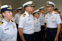 Rear Adm. John C. Acton, deputy commander for U.S. Coast Guard Mobilization and Reserve Affairs - Atlantic Area, inspects the reserve and active-duty Coast Guard troops assigned to U.S. Northern Command April 23 during a commissioning ceremony at Peterson Air Force Base for the new USNORTHCOM Coast Guard Reserve Unit. Capt. Douglas A. Ash commands the new reserve unit, which currently has five members and is expected to grow to 20 over the next few years. U.S. Northern Command and the U.S. Coast Guard effectively coordinate operations in multiple national defense mission areas, including maritime intercept operations, deployed port operations, maritime security and defense, peacetime engagement, and environmental defense operations.