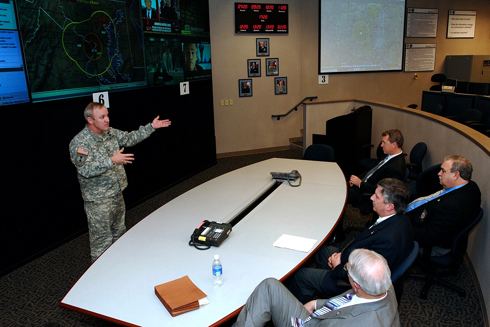 Colonel Tom Muir, left, director of the North American Aerospace Defense Command and U.S. Northern Command Command Center, briefs agency representatives attending USNORTHCOM's first State Partners Day April 25 at the commands' headquarters at Peterson Air Force Base, Colo.