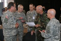 General Gene Renuart, commander, U.S. Northern Command, gets a close up look at the Department of Defense, Defense Support to Civil Authorities Automated Support System from Lt. Gen. Thomas Turner, U.S. Army North commanding general and members of his staff. The DDASS system allows Army North’s Joint Task Force Falcon track mission assignments requested by the Federal Emergency Management Agency. General Renuart was visiting JTF Falcon, which was deployed to Providence, R.I., in support of the hurricane venue of Exercise Ardent Sentry '07. 