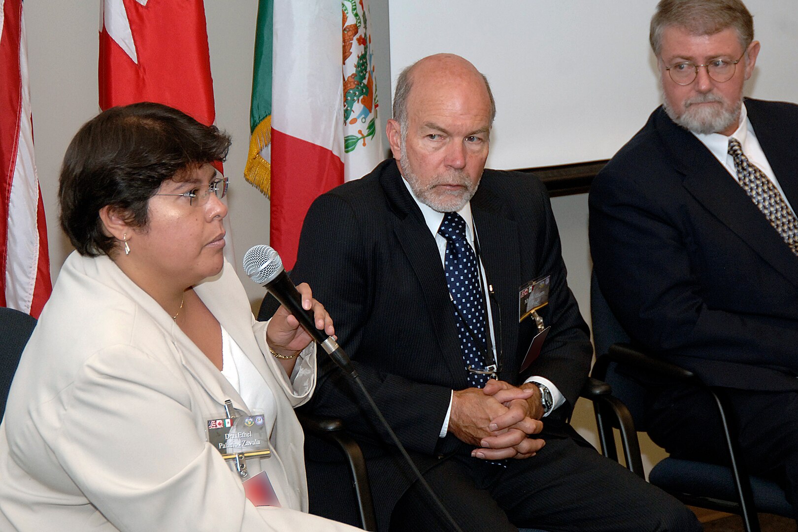 Dr. Ethel Palacios Zavala, deputy director of emergency preparedness for international health emergencies in the Mexico Ministry of Health, answers a question during a panel discussion at U.S. Northern Command's Tri-National Pandemic Influenza Conference, Sept. 5, 2007. Also on the panel were William Horne, center, secretariat of the pandemic influenza preparedness committee of Canada's Department of Foreign Affairs and International Trade, and William Lyerly Jr., director of international affairs and special assistant for global health security to the assistant secretary for health affairs, U.S. Department of Homeland Security. (Photo altered for security purposes.) 