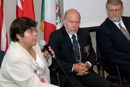 Dr. Ethel Palacios Zavala, deputy director of emergency preparedness for international health emergencies in the Mexico Ministry of Health, answers a question during a panel discussion at U.S. Northern Command's Tri-National Pandemic Influenza Conference, Sept. 5, 2007. Also on the panel were William Horne, center, secretariat of the pandemic influenza preparedness committee of Canada's Department of Foreign Affairs and International Trade, and William Lyerly Jr., director of international affairs and special assistant for global health security to the assistant secretary for health affairs, U.S. Department of Homeland Security. (Photo altered for security purposes.) 