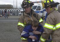 FAIRBANKS, ALASKA - Firemen from the University of Alaska Fairbanks Fire Department carry a simulated accident victim to a triage station May 8 as part of Alaska Shield/Northern Edge 2007. The exercises, which are scheduled to run from May 7-18, will test military and civilian authorities throughout Alaska on all aspects of emergency preparedness as they respond to a variety of scenarios ranging from natural disasters to major accidents. On May 8, the University Fire Department, along with other local rescue workers, responded to a simulated train collision involving hazardous materials and massive casualties.