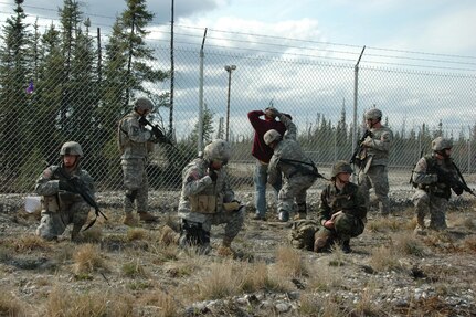 ]An Airman and Soldiers contain a suspected terrorist after finding an improvised explosive devise (IED) was found while searching his vehicle during an Entry Control Point (ECP) stop.  The ECP was established by members of the Nebraska National Guard and Alaska Air National Guard as part of an exercise conducted during Alaska Shield / Northern Edge 07.  Exercise Alaska Shield / Northern Edge 07 is a state of Alaska / US Northern Command sponsored homeland defense / defense support of civil authorities exercise; part of the national-level Ardent Sentry / Northern Edge 07 exercise.  Photo by Chief Mass Communications Specialist Greg Bingaman.