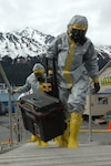 SEWARD, Alaska Ð Members of the National Guard's civil support team board the USNS Henry J. Kaiser in biohazard suits here May 11 to investigate a simulated report of suspicious chemicals aboard during an exercise scenario for Alaska Shield/Northern Edge 2007.  The civil support team worked in conjunction with the Seward police and fire departments, the Coast Guard, the FBI, and many other organizations to practice interagency coordination in an emergency situation.  AKS/NE 07 is a State of Alaska/US NORTHCOM sponsored homeland defense/defense support of civil authorities exercise; part of the national-level Ardent Sentry/Northern Edge 07.  U.S. Navy photo by Mass Communication Specialist 1st Class Daniel N. Woods