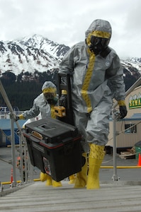 SEWARD, Alaska Ð Members of the National Guard's civil support team board the USNS Henry J. Kaiser in biohazard suits here May 11 to investigate a simulated report of suspicious chemicals aboard during an exercise scenario for Alaska Shield/Northern Edge 2007.  The civil support team worked in conjunction with the Seward police and fire departments, the Coast Guard, the FBI, and many other organizations to practice interagency coordination in an emergency situation.  AKS/NE 07 is a State of Alaska/US NORTHCOM sponsored homeland defense/defense support of civil authorities exercise; part of the national-level Ardent Sentry/Northern Edge 07.  U.S. Navy photo by Mass Communication Specialist 1st Class Daniel N. Woods