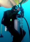 A U.S. Navy Diver attached to Mobile Diving Salvage Unit  (MDSU) 2 prepares a lift bag to salvage tires off the coast of Fort Lauderdale, Florida. MDSU-2 is conducting salvage operations in conjunction with U.S. Army Deep Sea Divers, and U.S. Coast Guard divers through the Innovative Readiness Training program. The goal of the salvage mission is to retrieve approximately two million tires. The tires were placed on the ocean floor in the 1970's to act as an artificial reef. However, coral would not stick to the rubber and the tires now present an environmental hazard. Salvage operations will continue for the next month then resume next year. U.S. Navy photo by Mass Communication Specialist 3rd Class Jack Georges