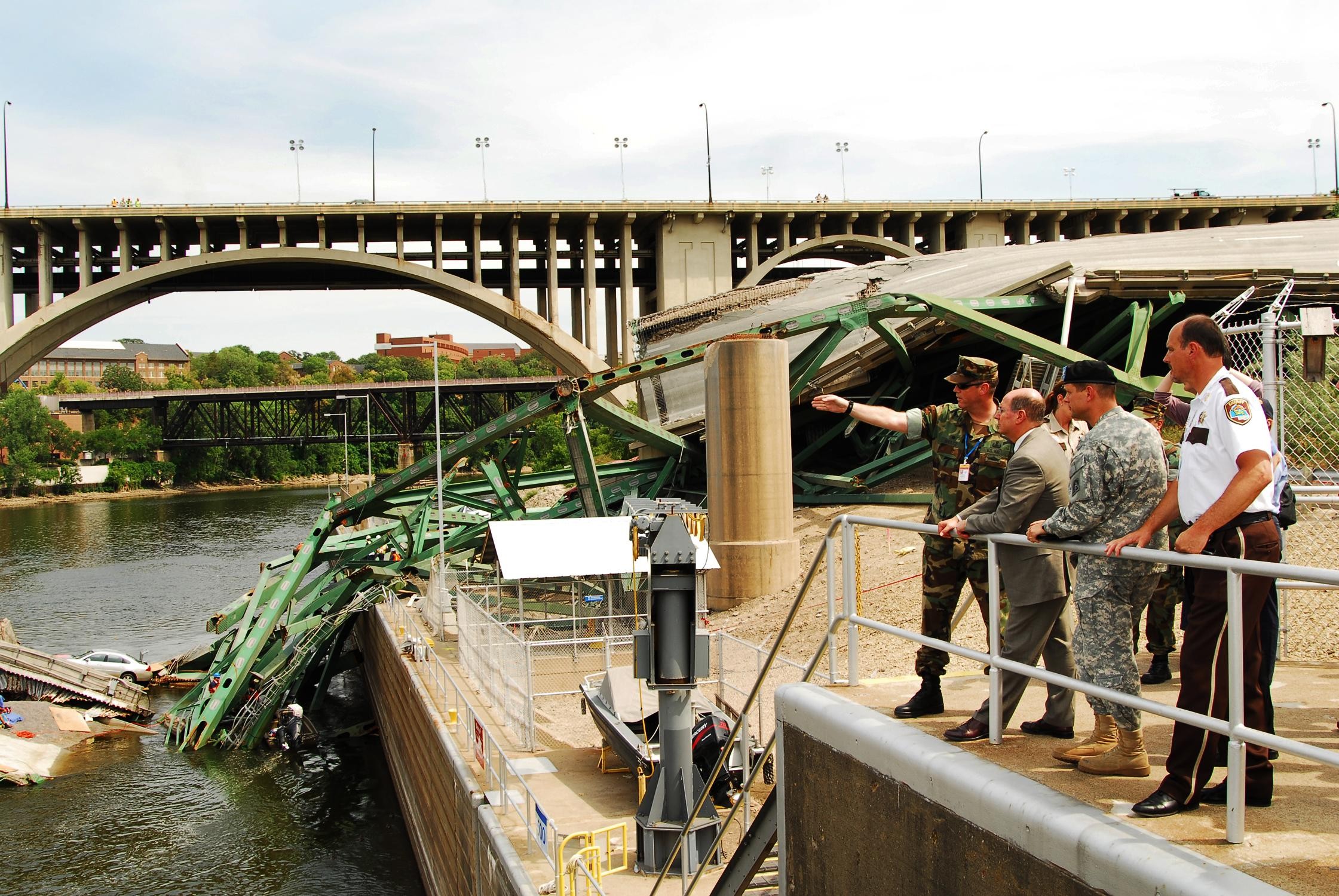 Honorable Donald C. Winter, tours the site of the I35 bridge collapse