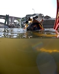 Navy Diver 1st Class William Eversmann of Mobile Diving and Salvage Unit (MDSU) 2 from Naval Amphibious Base Little Creek, Va., surfaces after a salvage dive in the Mississippi River. MDSU-2 is assisting other federal, state, and local authorities managing disaster and recovery efforts at the site of the I-35 bridge collapse. 
