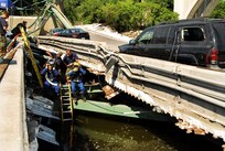 Navy divers from Mobile Dive and Salvage Unit 2 stationed at Naval Amphibious Base Little Creek prepare to enter the water of the I-35 bridge wreckage Aug. 07. When requested by the primary agency and approved by the Secretary of Defense, MDSU 2 may be utilized in support of civil authorities managing disaster recovery efforts. U.S. Navy photo by Mass Communication Specialist Seaman Joshua Adam Nuzzo (RELEASED)
 