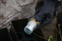 A Marine with Ammunition Company, 2nd Supply Battalion, 2nd Marine Logistics Group removes an artillery fuse before placing it with other explosives during an explosive ordnance disposal, or EOD, exercise aboard Camp Lejeune, N.C., May 7, 2013. The company trained with EOD Marines to learn safe methods of demolishing unserviceable munitions.
