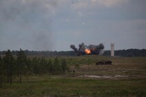 A cloud of smoke and fire bursts from a stash of obsolete ammunition during an explosive ordnance disposal, or EOD, exercise held by Ammunition Company, 2nd Supply Battalion, 2nd Marine Logistics Group aboard Camp Lejeune, N.C., May 7, 2013. The company set up the explosives to prepare for possible EOD operations, which the unit may encounter in the future.