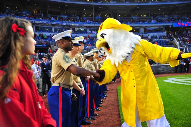 Screech, the Washington National's Mascot, poses with the starting lineup of Marines at Marine Corps day at Nationals Park on May 8, 2013. Marine Corps day is the first of five branch-themed days National's Park has scheduled for the season to recognize and show appreciation for the men and women who serve in the United States armed forces.