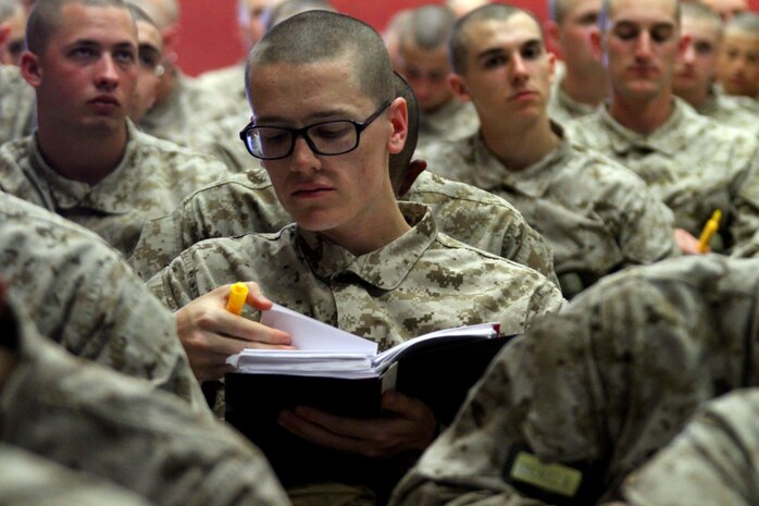 A recruit with Company F, 2nd Recruit Training Battalion, follows along in his textbook during the Equal Opportunity class aboard Marine Corps Recruit Depot San Diego April 26. During the class, recruits learned about the resources available to them in case they experience discrimination.