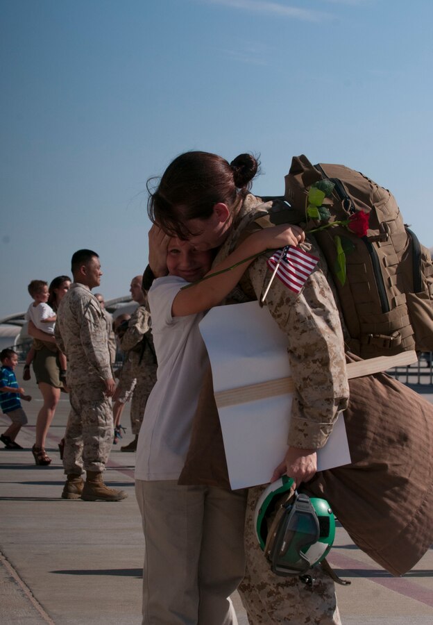 Without a moment to spare, Marine Attack Squadron 311 Staff Sergeant Jennifer Blesi embraces her child on the Marine Corps Air Station Yuma flight line May 13 after a six deployment aboard the USS Peleliu in support of the 15th Marine Expeditionary Unit.  Blesi served alongside approximately 2,400 Marines and Sailors as a part of the Peleliu Amphibious Ready Group.  The 15th MEU provides a forward deployed, flexible sea-based Marine Air Ground Task Force (MAGTF) capable of conducting amphibious Operations, crisis response and limited contingency operations, to include enabling the introduction of follow-on forces, and, designated special operations, in order to support the theater requirements of Geographic Combatant Commanders.