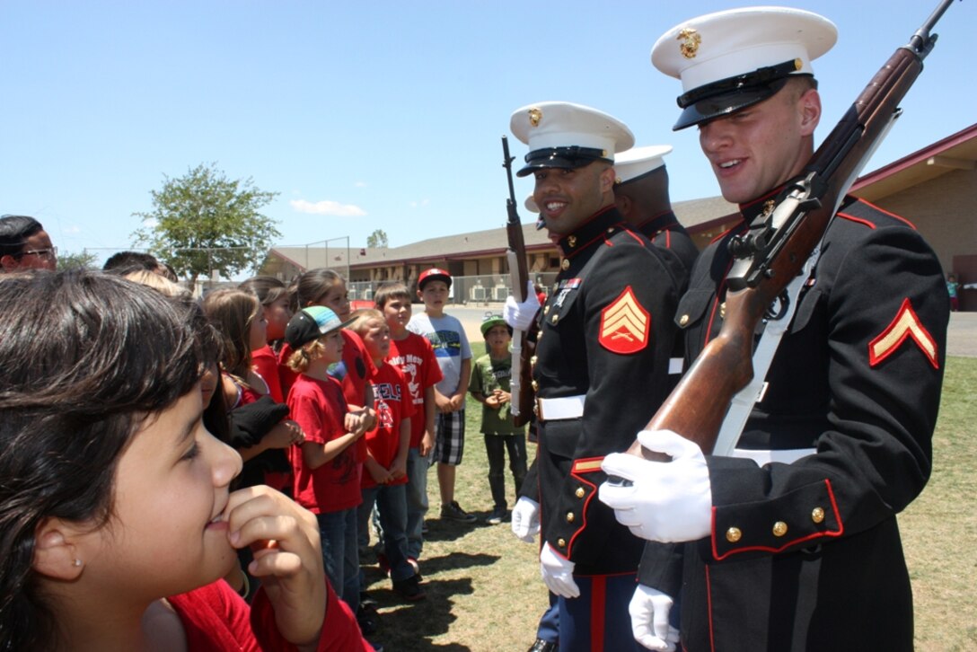 Pfc. Samuel Ranney (right), and Sgt. Julio Acevedo (left), with Marine Corps Logistics Base Barstow, answer questions and talk with students at Baldy Mesa Elementary School in Phelan, Calif., May 10. The Marines participated in the Welcome Home Heroes ceremony that recognized local firefighters, local law enforcement, and military service members.