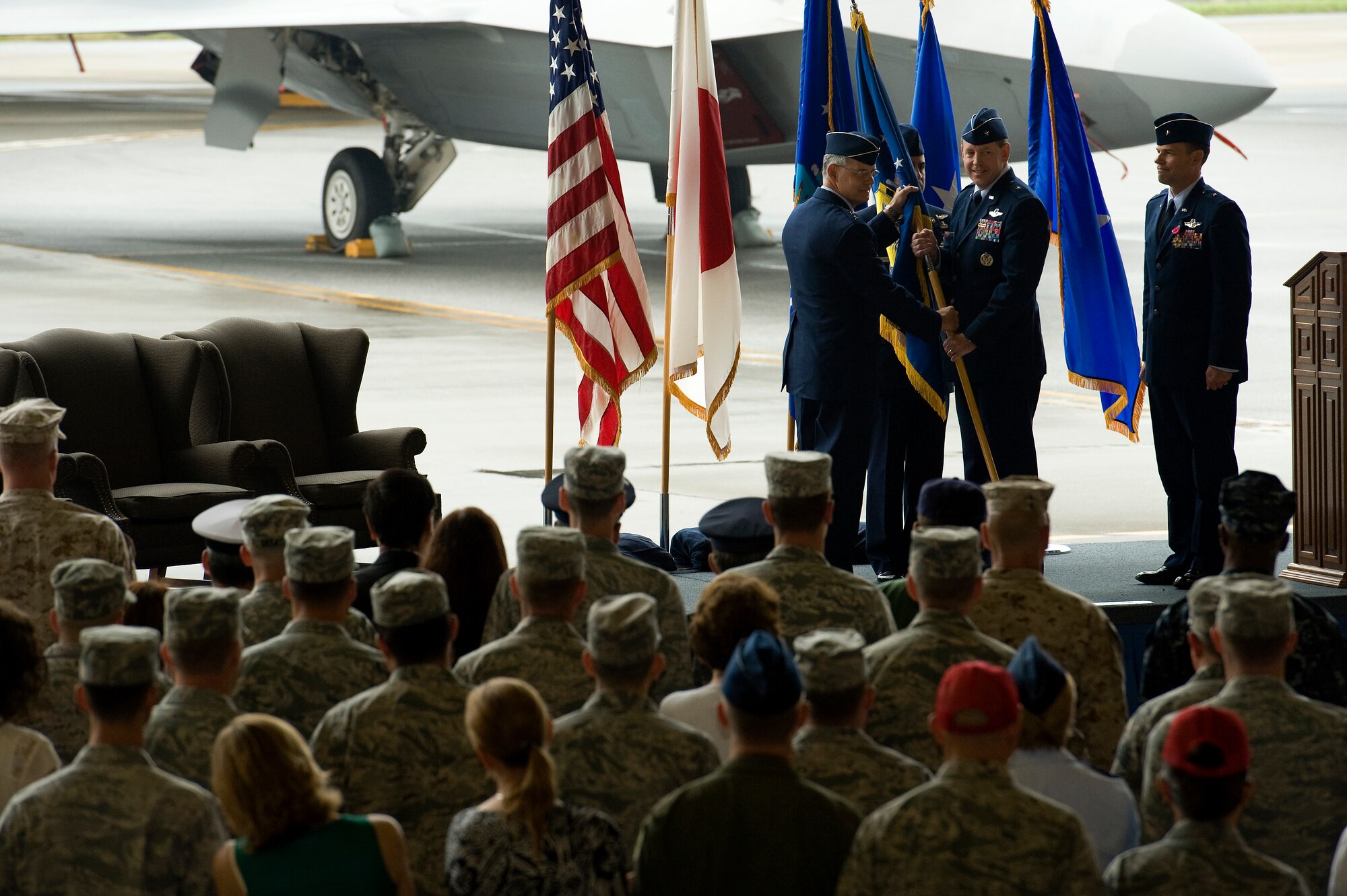U.S. Air Force Lt. Gen. Salvatore Angelella, 5th Air Force and U.S. Forces, Japan, commander, passes the 18th Wing guidon to Brig. Gen. James Hecker, new 18th Wing commander, during the 18th Wing change of command ceremony on Kadena Air Base, Japan, May 13, 2013. During the ceremony, Brig. Gen. Matt Molloy relinquished command of the wing as he continues his Air Force career as the U.S. Northern Command deputy director of operations at Peterson Air Force Base, Colo. (U.S. Air Force photo by Senior Airman Maeson L. Elleman/Released)
