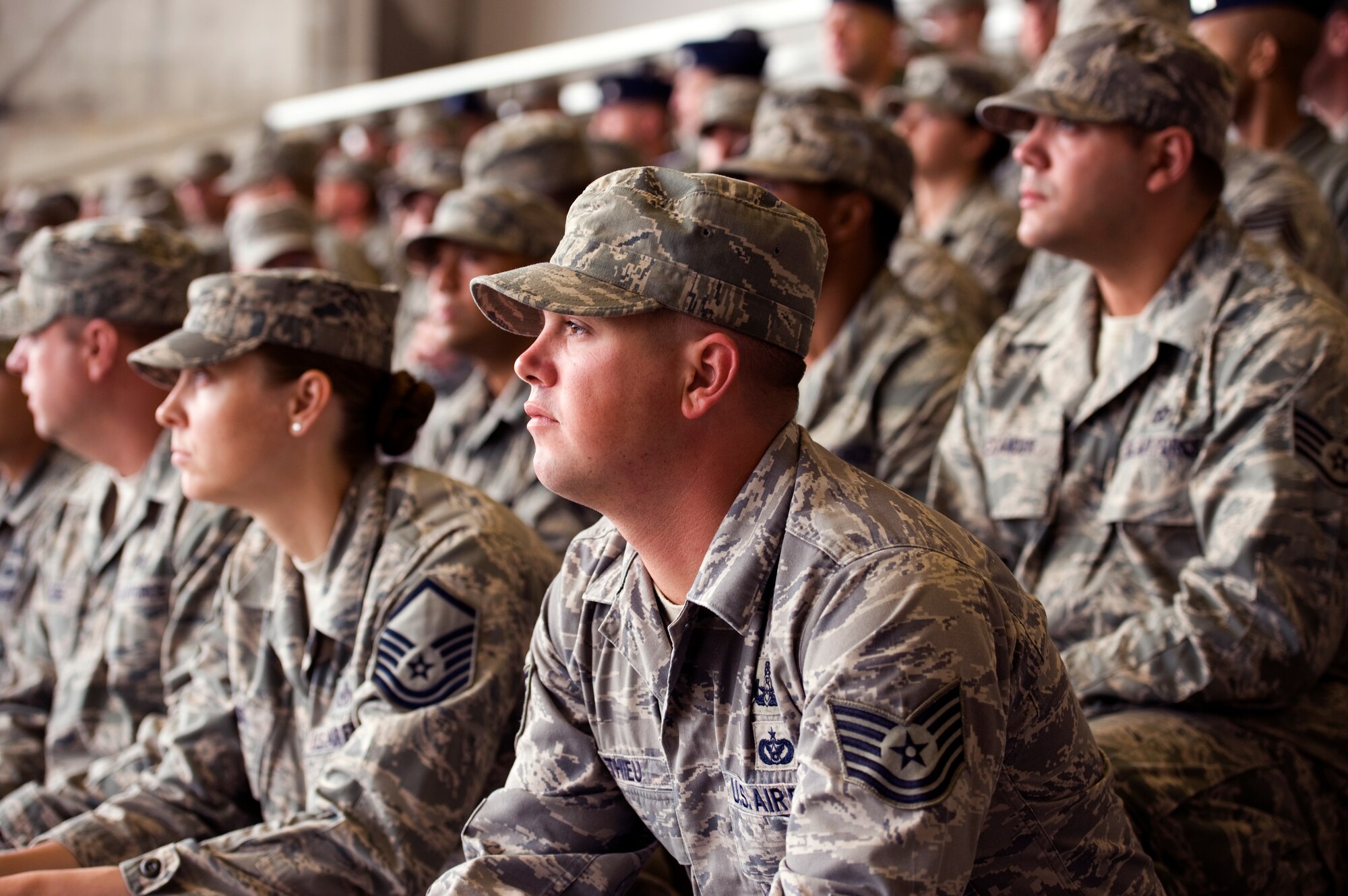 U.S. Air Force Airmen from the 18th Wing watch the ceremony procession during the 18th Wing change of command ceremony on Kadena Air Base, Japan, May 13, 2013. During the ceremony, command of the 18th Wing was relinquished by Brig. Gen. Matt Molloy and passed to Brig. Gen. James Hecker, who will serve as the wing commander for the next two years. (U.S. Air Force photo by Senior Airman Maeson L. Elleman/Released)