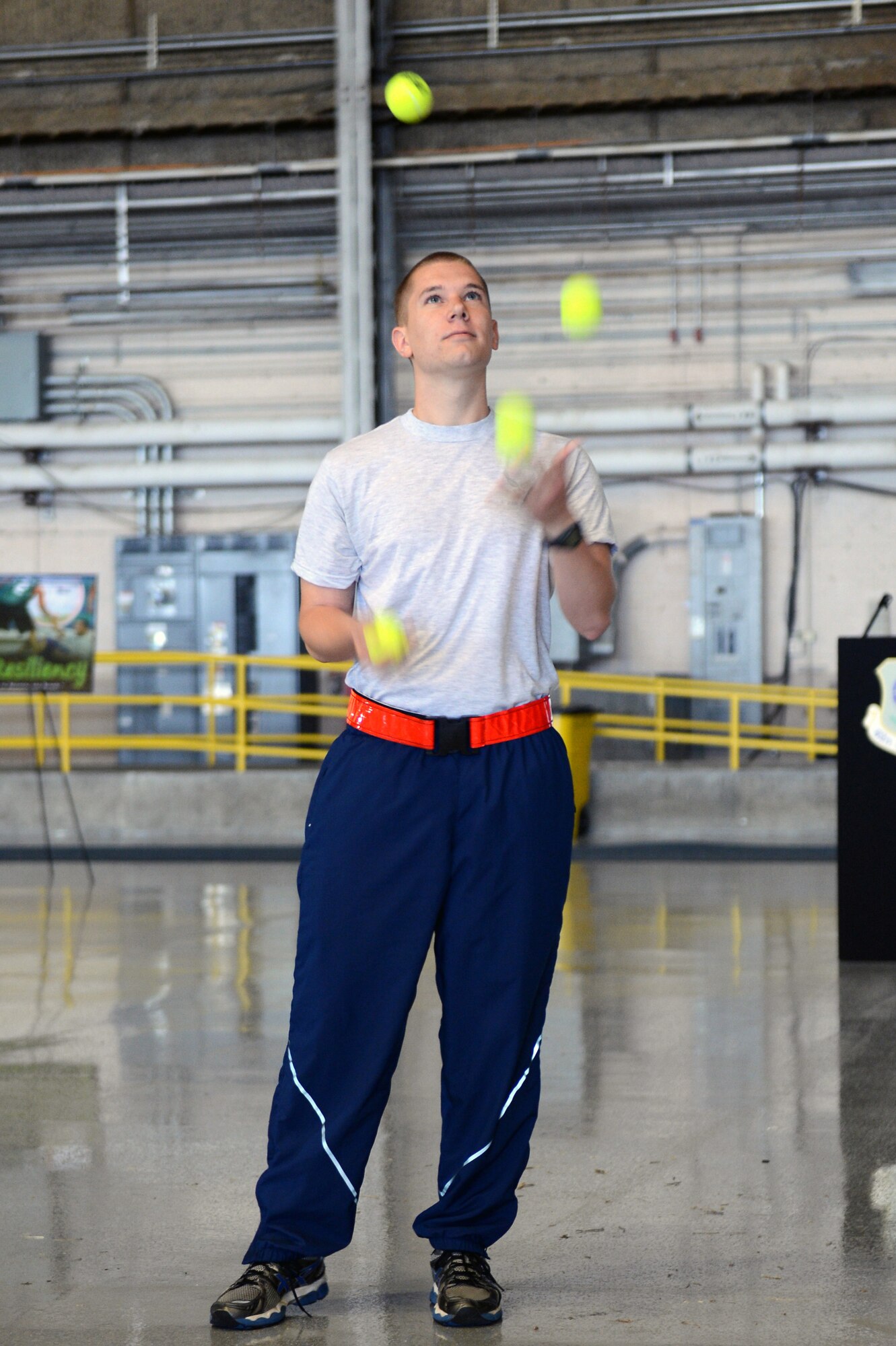 An Airman juggles tennis balls May 10, 2013 as part of an activity during Team McChord's Wingman Day at Joint Base Lewis-McChord, Wash. The act of juggling tennis balls shows how difficult life can be when multiple stressors are happening at once. (U.S. Air Force photo/Staff Sgt. Jason Truskowski)