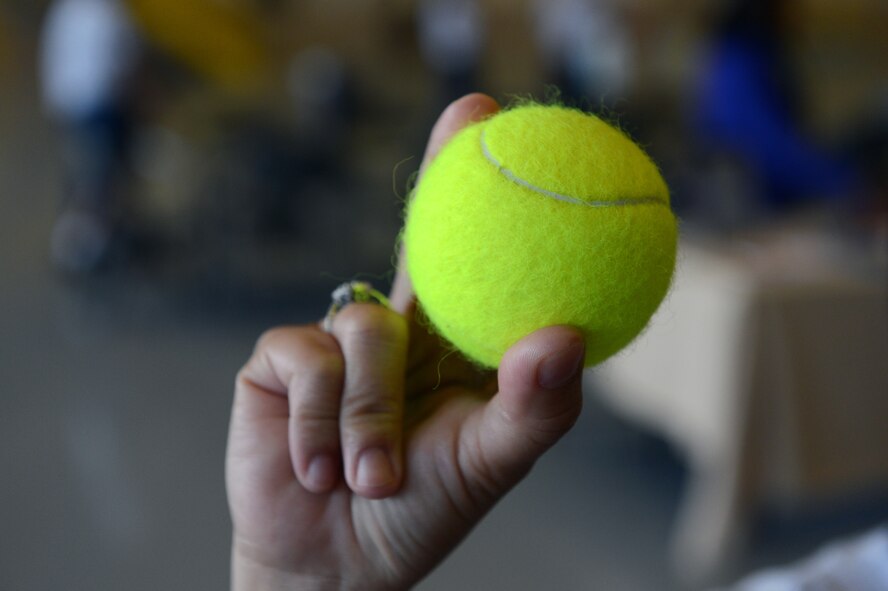 An Airman receives a tennis ball during Wingman Day May 10, 2013 at Joint Base Lewis-McChord, Wash. The tennis ball is the symbol of Airmen bouncing back after challenges they have faced during their lives. (U.S. Air Force photo/Staff Sgt. Jason Truskowski)