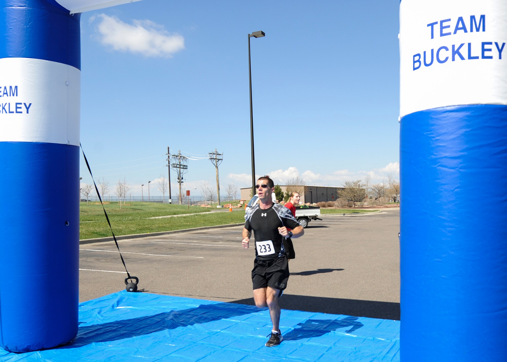 Norman Miniger, an Army staff sergeant with the 743rd Military Intelligence Battalion, crosses the finish line of the 7th Annual Buckley Half Marathon with a time of 1 hour, 18 minutes, 20 seconds May 11, 2013, on Buckley Air Force Base, Colo.  The back-to-back winner of the annual race said he began running in 2008 when he felt he was overweight. He now runs about 20 races a year. Miniger recently completed the Boston Marathon with a time of 2:45. (U.S. Air Force photo by Staff Sgt. Christopher Gross/Released)