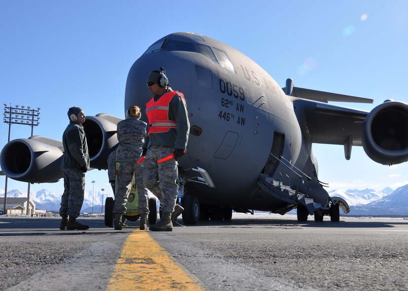 Tech. Sgt. Eddie Maldonado (orange vest), 446th Aircraft Maintenance Squadron aircraft maintenance technician out of McChord Field, Wash., prepares to block out in order to marshal a McChord C-17 Globemaster III the aircraft before takeoff, April 25 at Joint Base Elmendorf-Richardson, Alaska. Maldonado and other Reservists from the 446th AMXS were at JBER fulfilling their two-week annual training requirements with the 732nd Air Mobility Squadron, JBER, April 21 to May 5. (U.S. Air Force photo/Tech. Sgt. Dana Rosso)